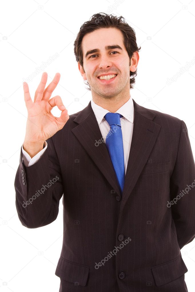 Happy young business man gestures ok sign, isolated on white