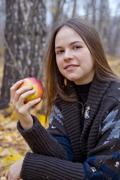 Porträtt av brunhårig tjej med äpple — Stockfoto