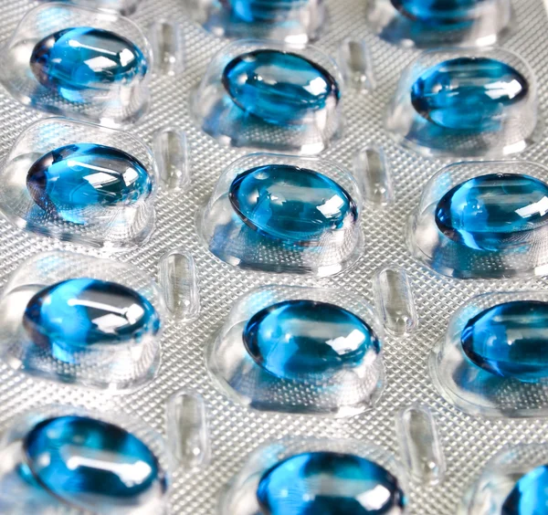 Modré pilulky v kontejneru — Stock fotografie
