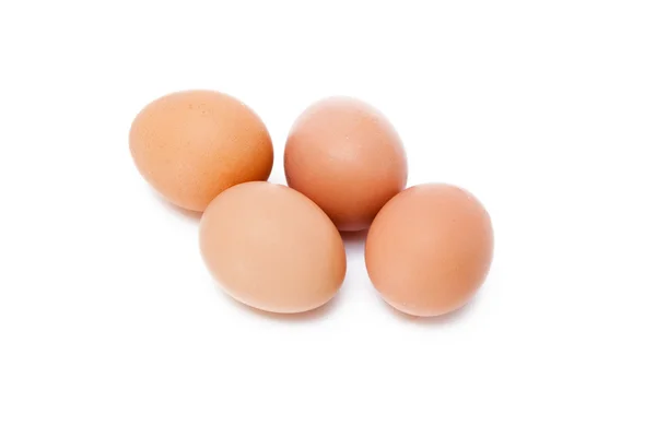 Tio ägg i en kartong på isolerade bakgrunden Stockbild