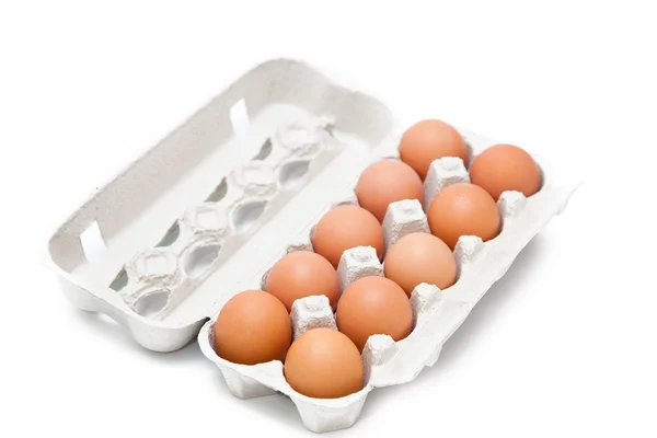 Ten eggs in a carton on the isolated background Royalty Free Stock Images