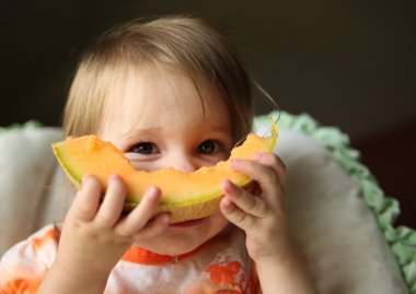 Baby eating cantaloupe clipart