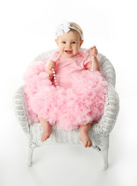 Baby girl wearing pettiskirt tutu and pearls clipart