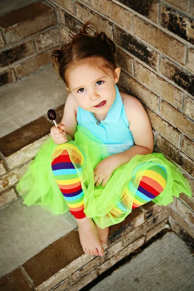 Дошкольная девочка с пачкой и конфеткой. — стоковое фото
