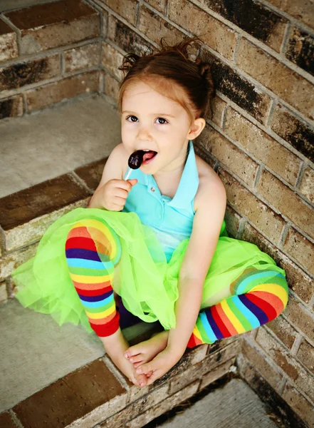 Дошкольная девочка с пачкой и конфеткой. — стоковое фото