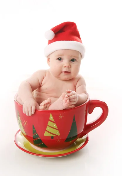 Papai Noel bebê em uma caneca grande — Fotografia de Stock