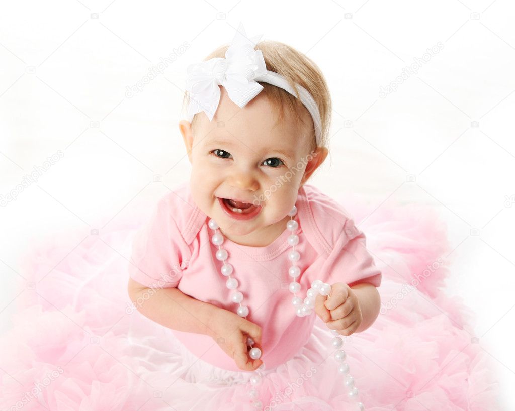 Smiling baby girl wearing pettiskirt tutu and pearls