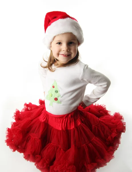 Liten flicka klädd i christmas santa hat och röd pettiskirt — Stockfoto
