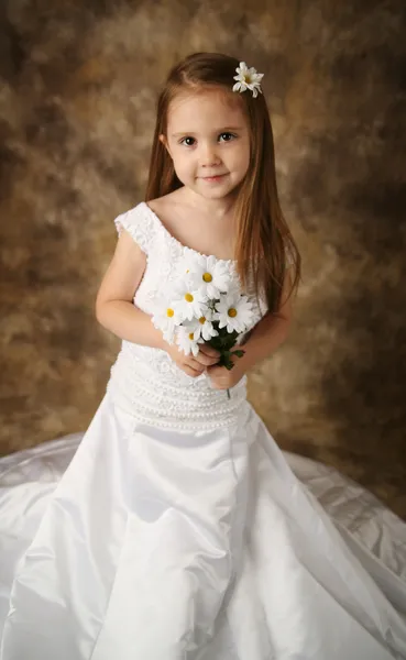 Little girl trying on mommy's wedding dress Stock Photo