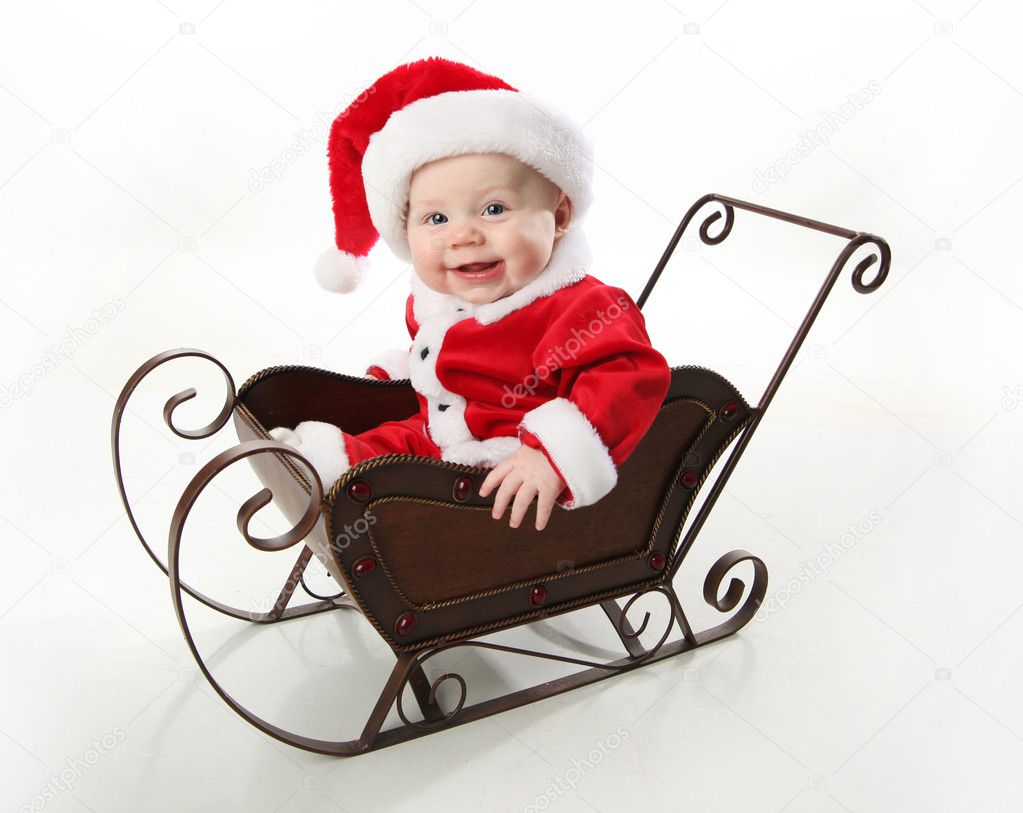 Santa baby sitting in a sleigh