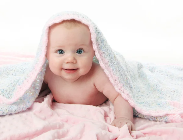 Beautiful baby under a blanket — Stock Photo, Image