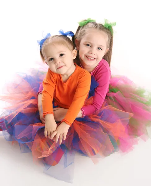 Duas Irmãs Adoráveis Vestidas Com Tutus Coloridos Brilhantes Sentados Abraçando — Fotografia de Stock
