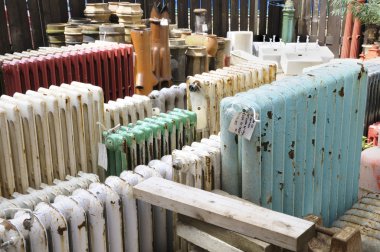 Old radiators at an architectural salvage yard. clipart