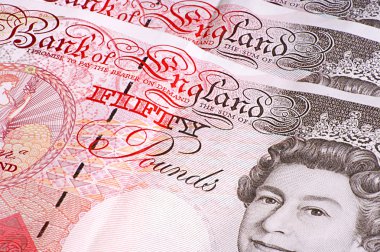 Close-up of an array of UK fifty pound notes clipart