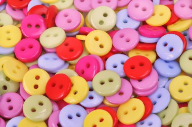 A scatter of brightly colored clothing buttons clipart