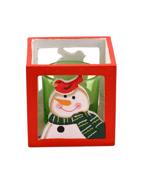 Roter Leuchter mit Schneemann und grüne Kerze — Stockfoto
