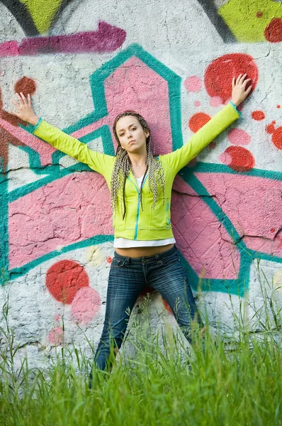 Girl on graffiti background — Stock Photo, Image