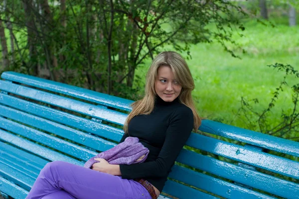 Девушка с шарфом на скамейке — стоковое фото