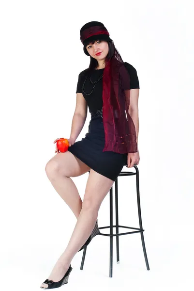 Girl with apple on stool — Stock Photo, Image