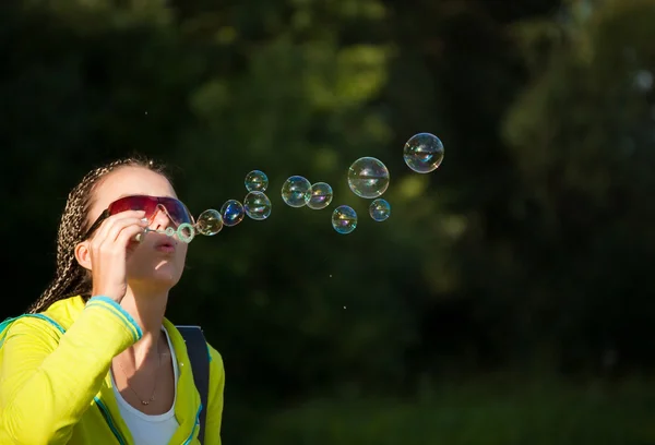 Stock image Beauty girl belly soap bubbles on nature background