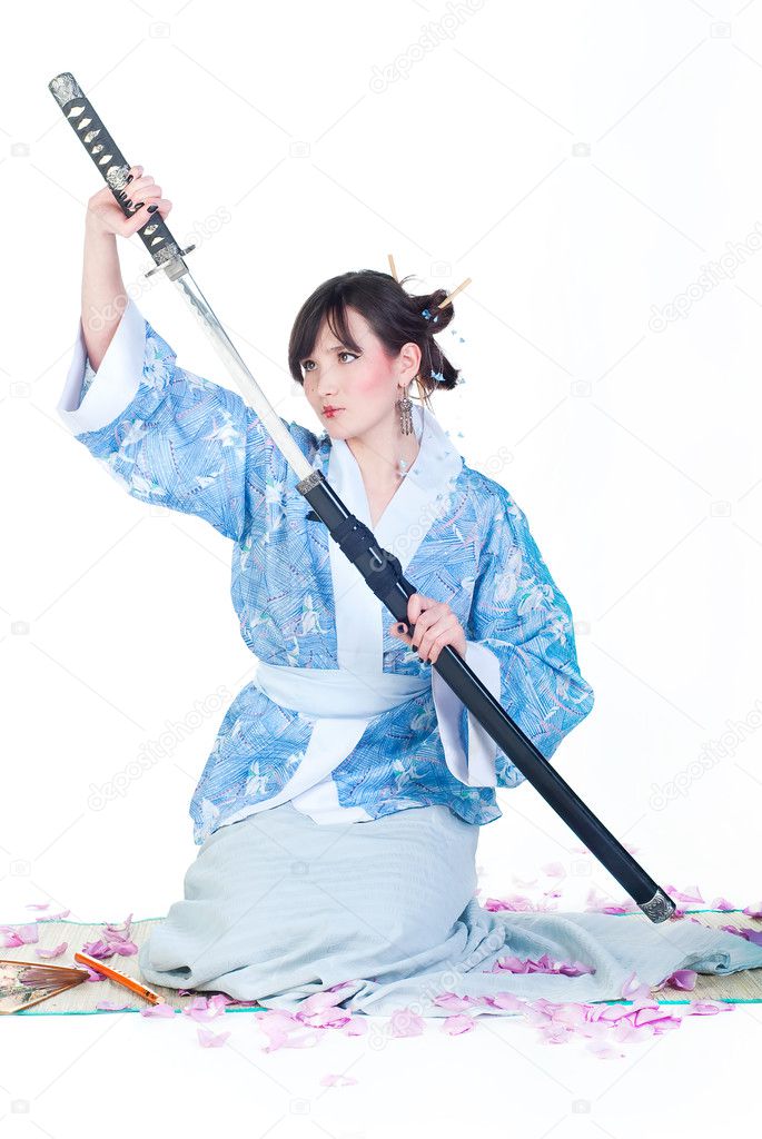 Beauty geisha in blue kimono with katana isolated on white background
