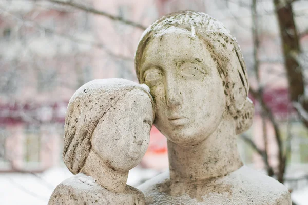 stock image Sculpture of mother and child in the winter on abstract background