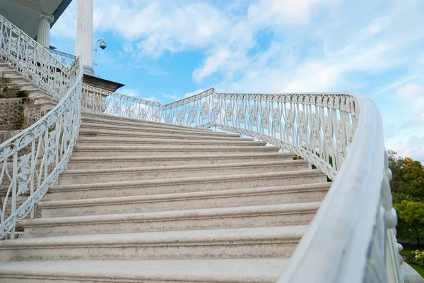 stock image Marble old-fashioned stairway with handrails on the sky background