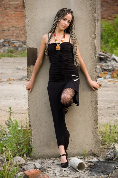 Fashionable Girl Black Dress Alongside Column Dirty Industrial Place — Stock Photo, Image
