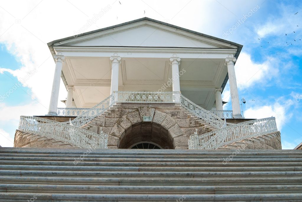 Entrance to the museum with ancient stairs along the edges on the sky background