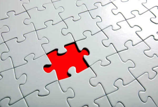 Missing puzzle piece, focus around the empty space. — Stock Photo, Image