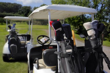 Two golf cart with clubs ready to go clipart