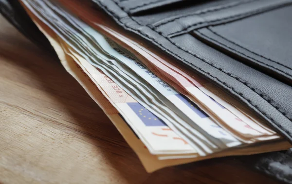 Euro notes protruding from wallet — Stock Photo, Image
