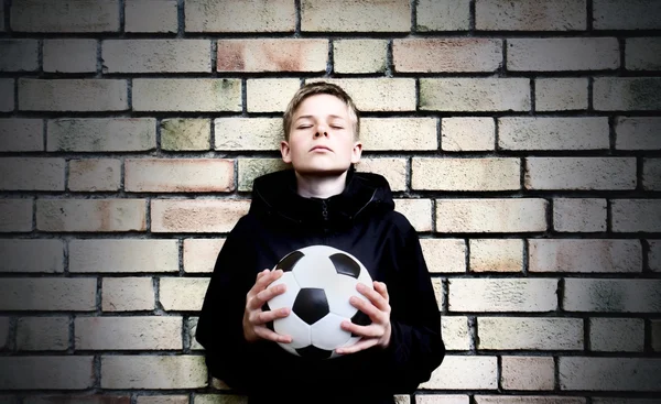 stock image A boy against a wall with a ball