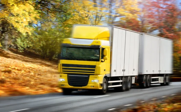Truck driving on country-road/motion — Stock Photo, Image