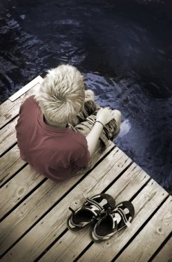 Boy sitting on a Footbridge clipart