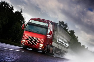 Truck driving on country-road clipart