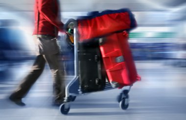 Man with red bags at the airport clipart