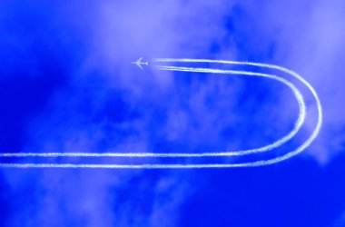 Airplane in the sky with jet trail clipart