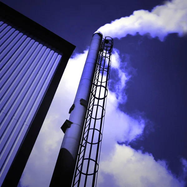 Chimney with fumes on blue clear sky — Stock Photo, Image