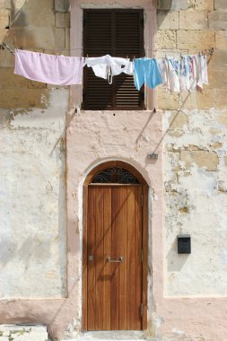 Washing line in front of a window clipart