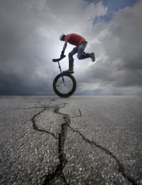 Young man unicycle on the street clipart