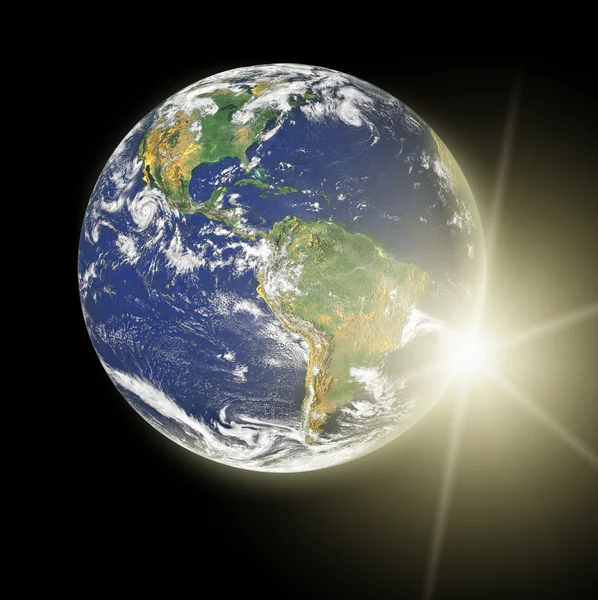 Реальная планета Земля под желтым солнцем — стоковое фото