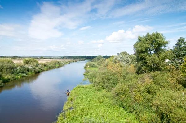 stock image Small blue river surround the green banks. Sunny day. Belarus.