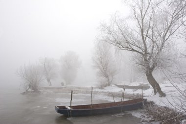 Traditional fishing boat in winter clipart