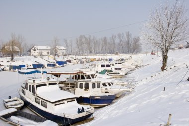 Old boats in frozen marina clipart