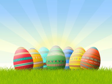 Painted Easter eggs in the grass clipart