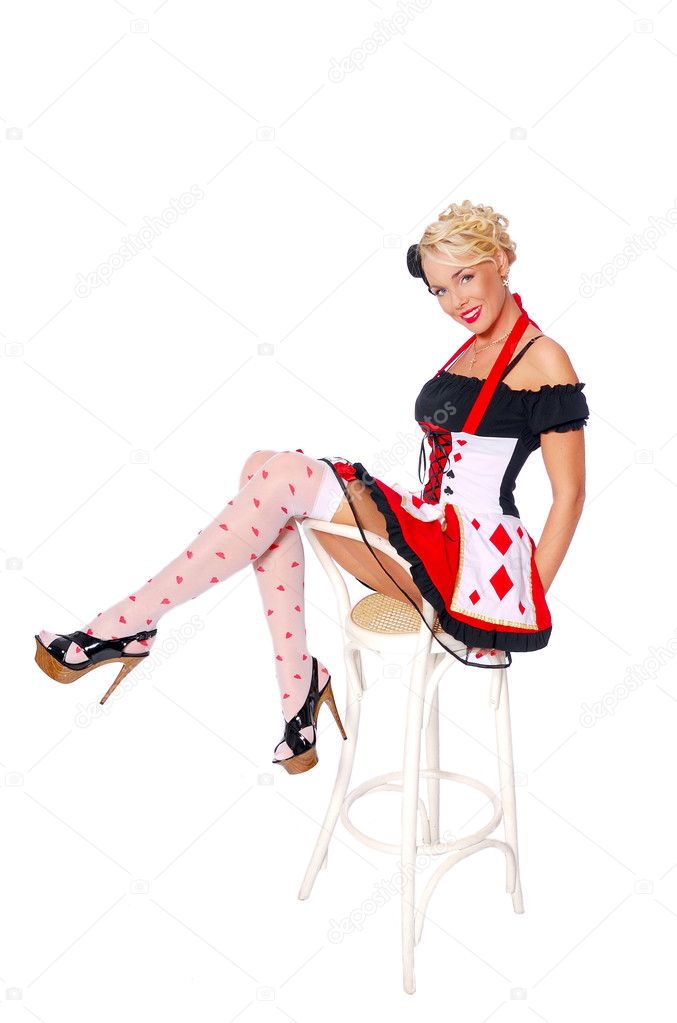 Sexy girl in a queen of hearts costume sit on the chair and show long legs