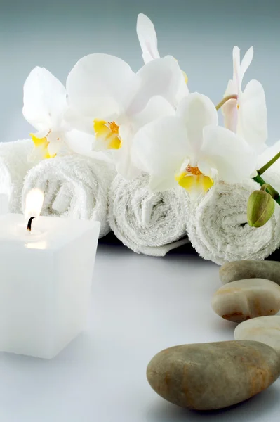 Białe ręczniki i kamienie i świeca — Zdjęcie stockowe