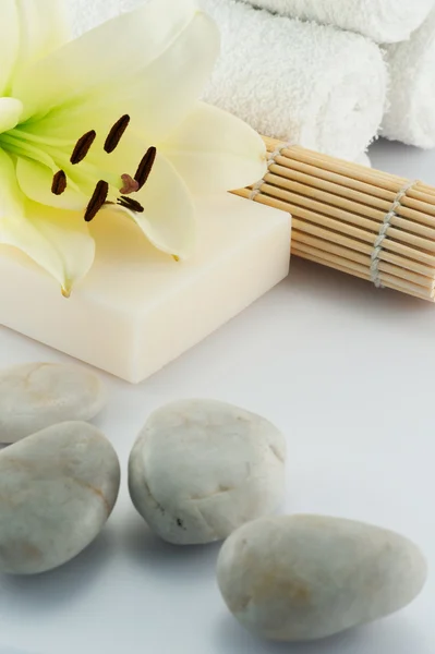 Soap on white towels with orchid and bamboo — Stock Photo, Image