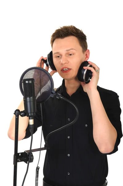 stock image Young man with microphone on white background